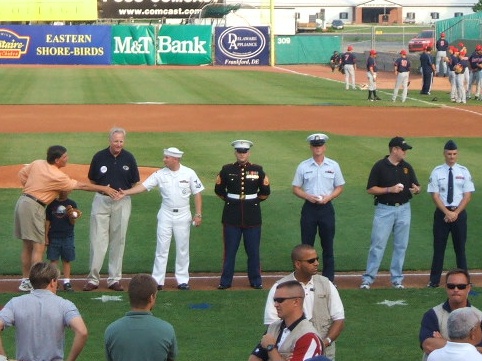 Governor Ehrlich greets the Navy's representative as the military is honored in a pregame ceremony.